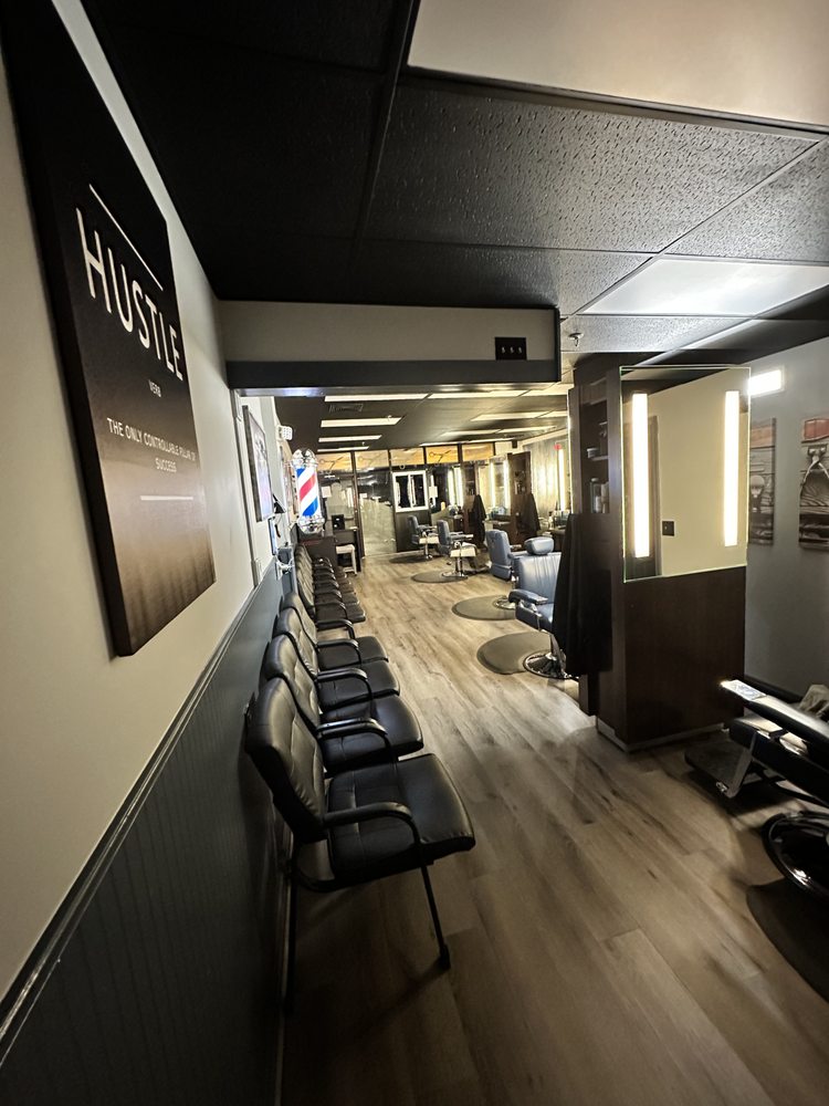 Waiting area at Jimmy C's Barber Shop with the barber pole in view