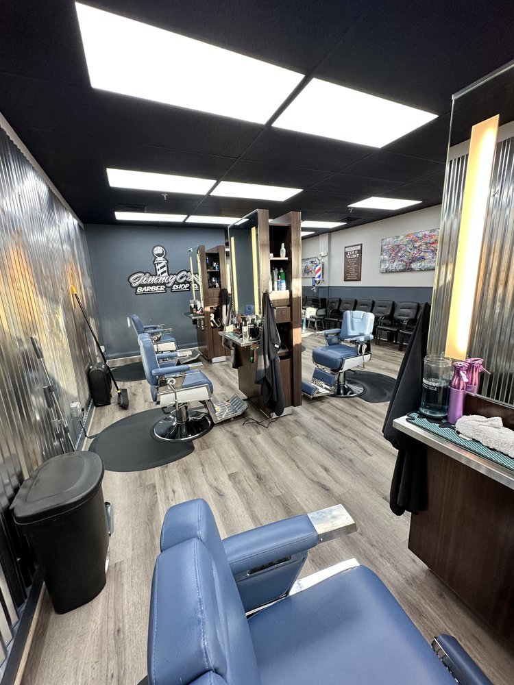 Jimmy C's logo on the wall above the barber chairs